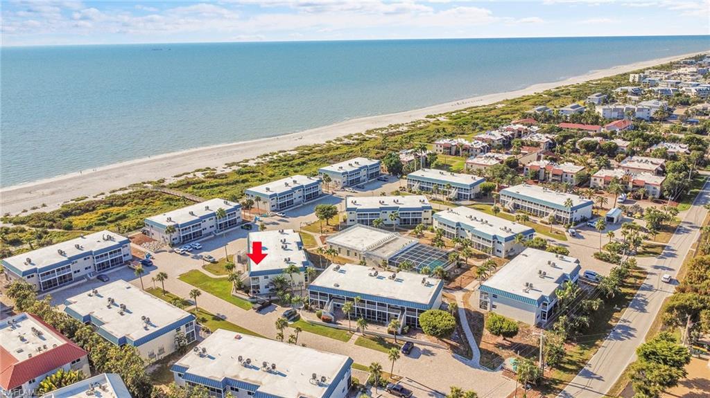 Image 1: Just a few steps carry you from your front door to the white-sand beaches of Sanibel Island, where mornings begin with seashells glittering in the tide and evenings melt into watercolor sunsets.