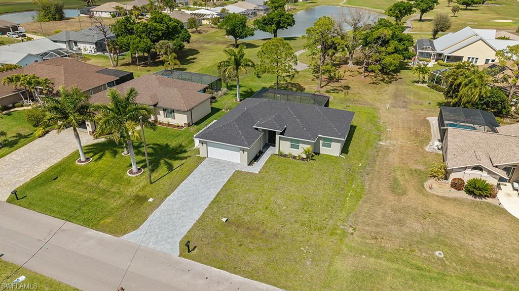 Image 2: Aerial perspective of suburban area with a nearby body of water and a golf club