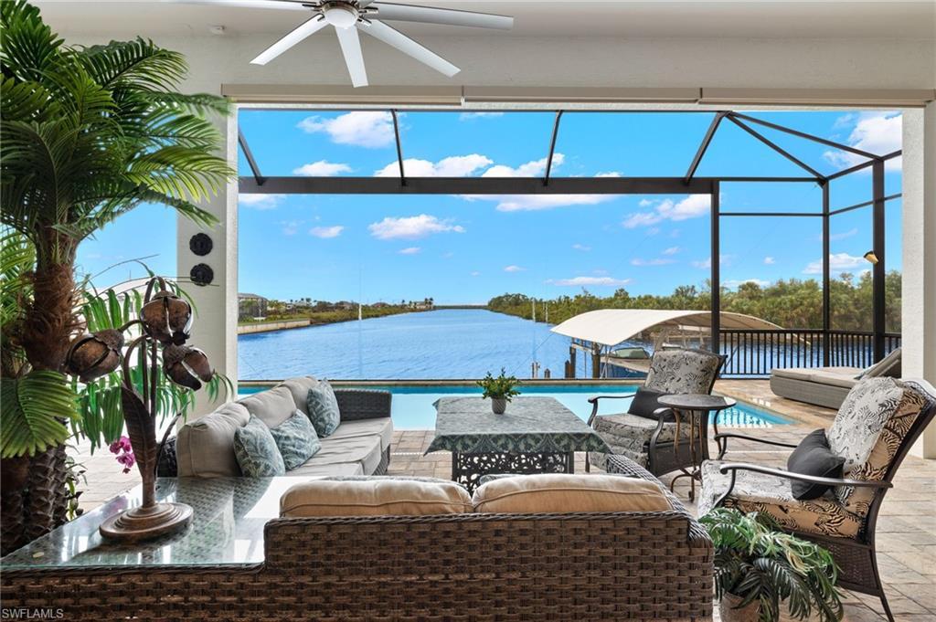 Image 3: View of patio with amazing water views over the pool through the picture window screen enclosure