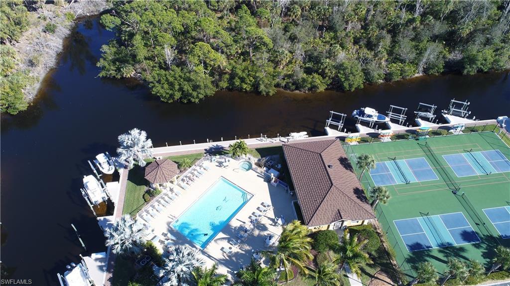 Image 3: Bird's eye view of a nearby body of water and a pool area