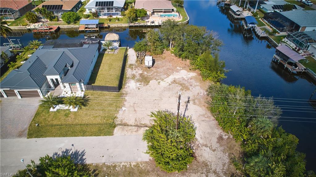 Image 3: Aerial perspective of suburban area with a large body of water
