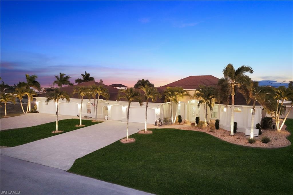 Image 1: Yard at dusk featuring a lawn and driveway