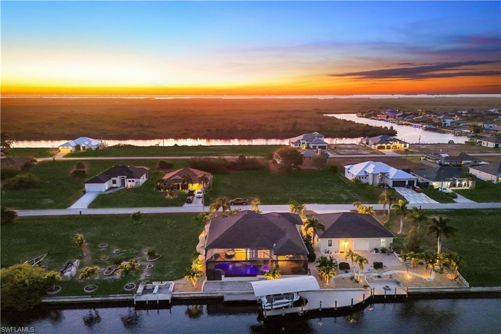 Image 3: Aerial view of residential area with a nearby body of water