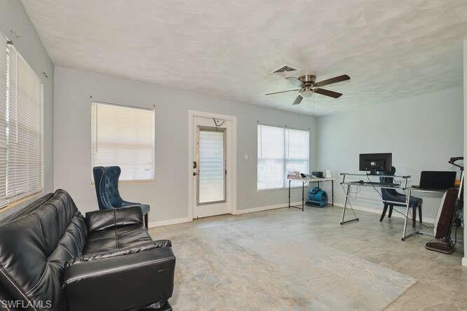 Image 4: Living area featuring an office area and ceiling fan