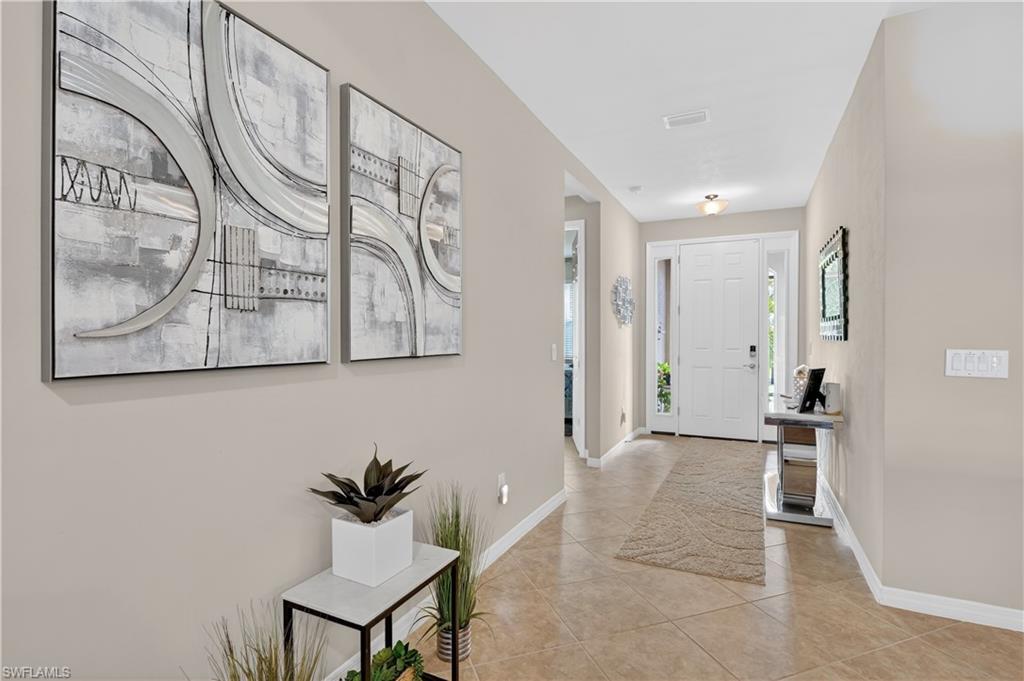 Image 4: Foyer featuring baseboards and light tile patterned floors
