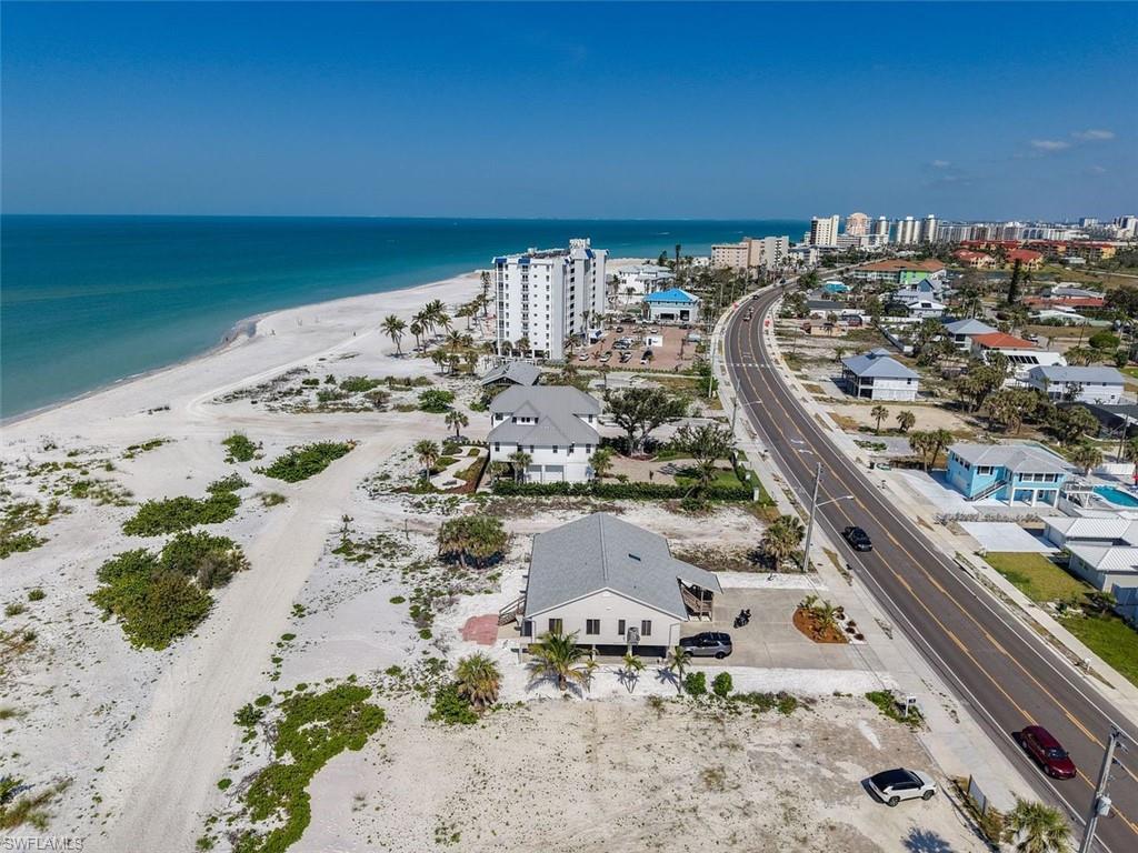 Image 4: Bird's eye view of waterfront with a beach