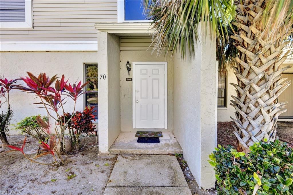 Image 3: Property entrance featuring stucco siding