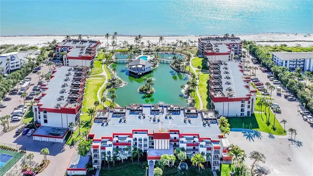 Image 1: Bird's eye view of a nearby body of water and apartment complex