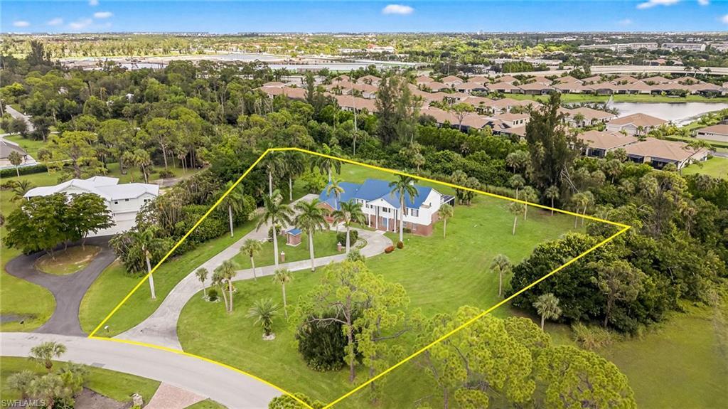 Image 1: Aerial perspective of suburban area with a nearby body of water and property boundaries highlighted