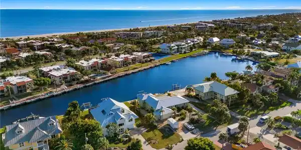 Image 2: Aerial perspective of suburban area with a large body of water