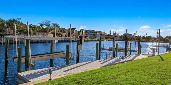 Image 3: Dock with a yard, a water view, a residential view, and boat lift