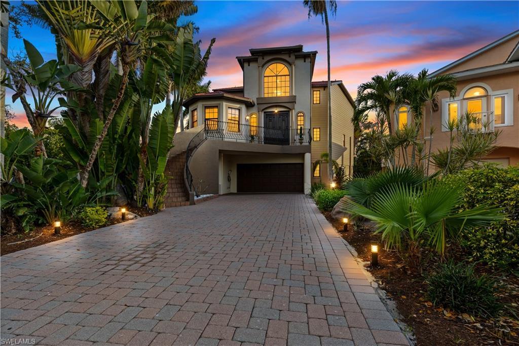 Image 1: Mediterranean / spanish-style house with stucco siding, decorative driveway, an attached garage, and a balcony