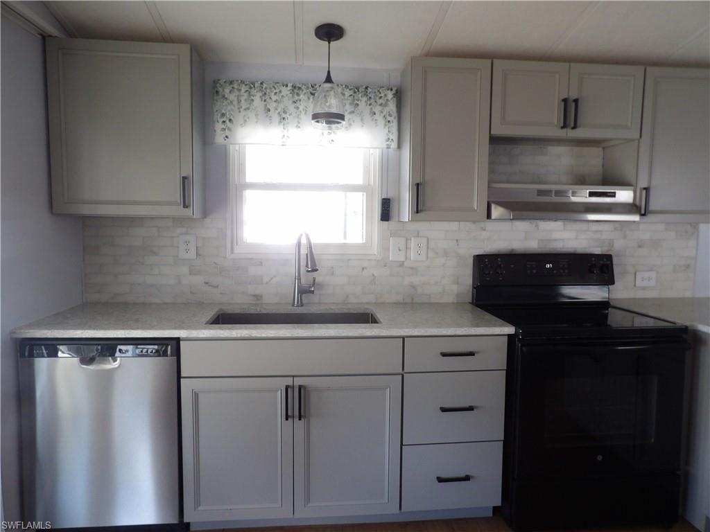 Image 4: New Kitchen featuring black / electric stove, dishwasher, light stone countertops, decorative light fixtures, and tasteful backsplash