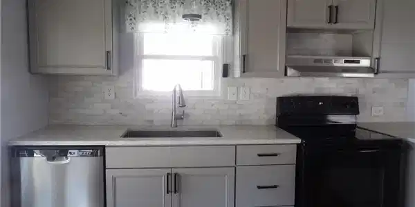 Image 4: New Kitchen featuring black / electric stove, dishwasher, light stone countertops, decorative light fixtures, and tasteful backsplash