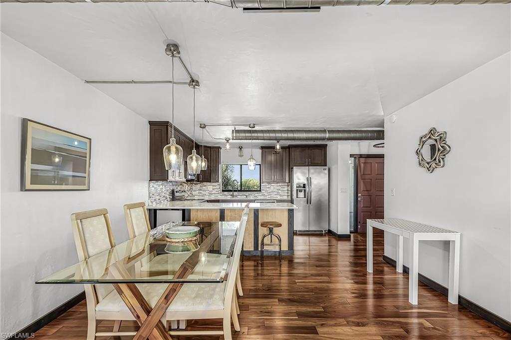 Image 3: Dining area with wood-style floors and baseboards