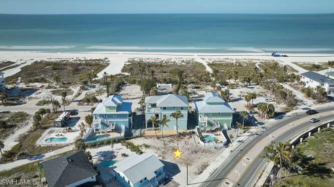 Image 1: Bird's eye view with a water view and a view of the beach