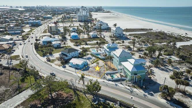 Image 3: Birds eye view of property with a water view and a view of the beach