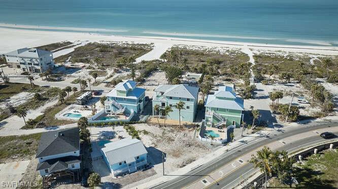 Image 4: Birds eye view of property with a water view and a view of the beach
