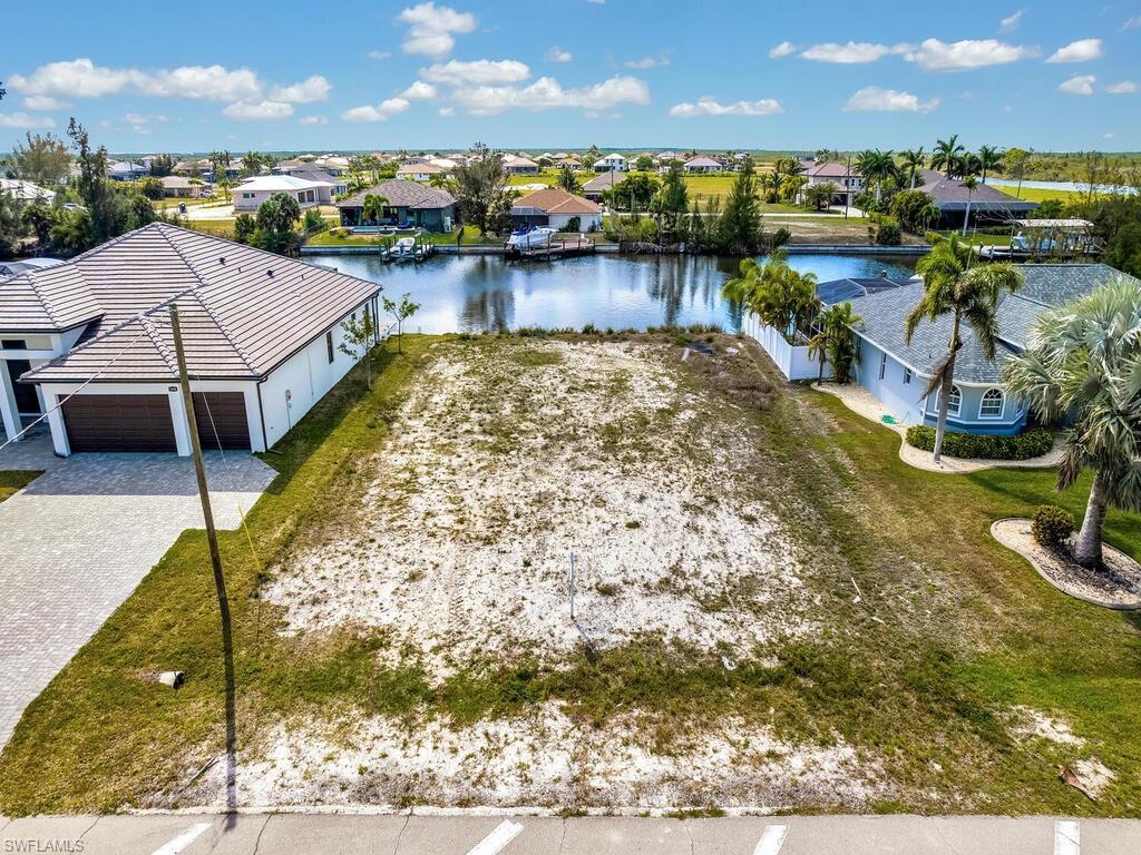 Image 2: Aerial view of residential area with a large body of water