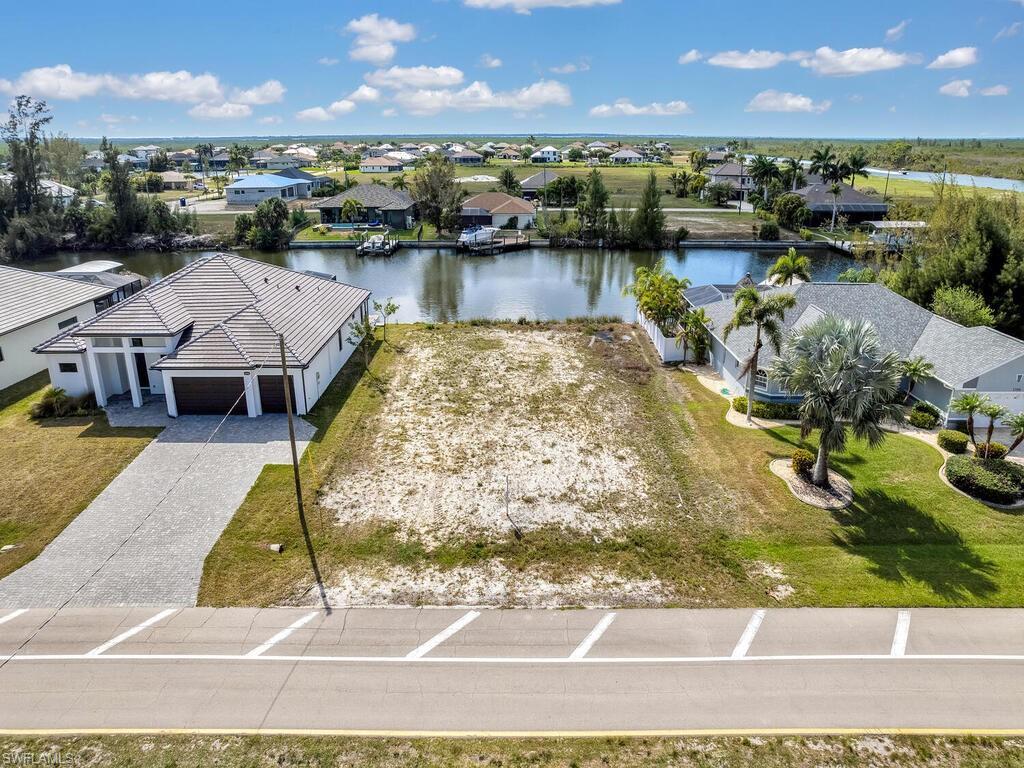 Image 3: Aerial view of residential area with a large body of water