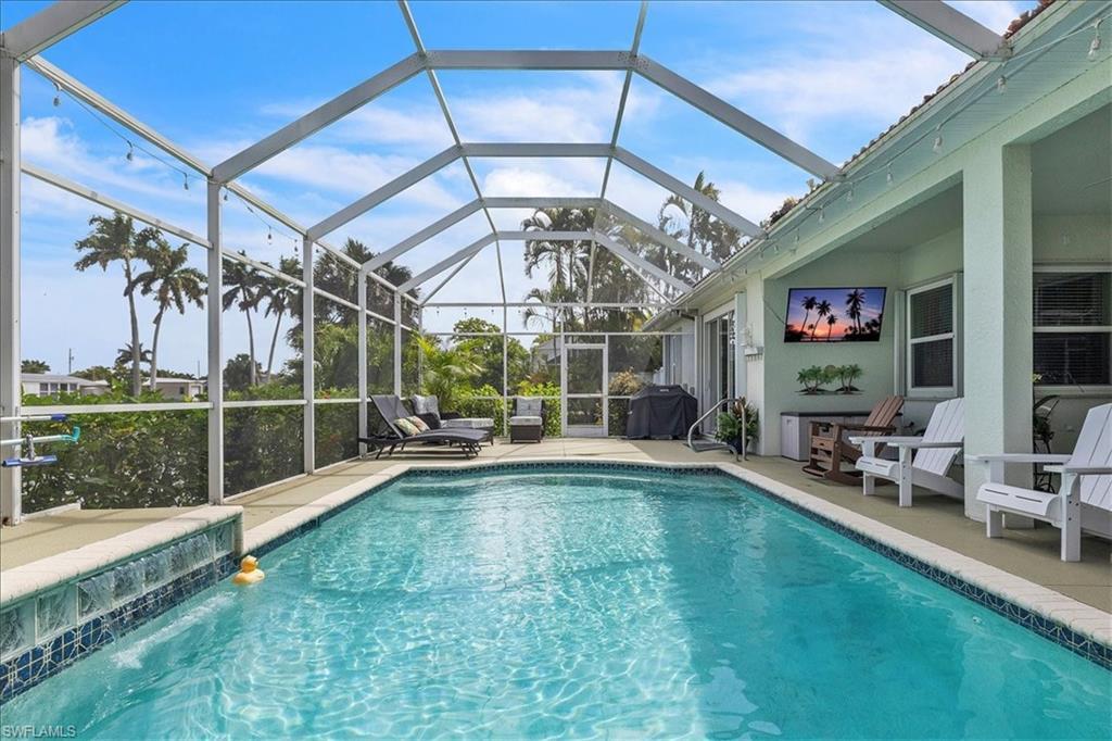 Image 2: Swimming pool featuring a patio area, a lanai, and grilling area