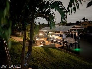 Image 3: Dock featuring 8000 pound boat lift and a yard with snook light.