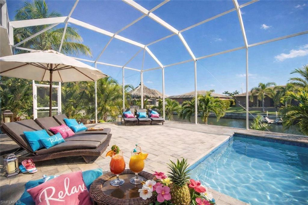 Image 3: Outdoor pool with a lanai, a sunroom, a water view, and a patio area