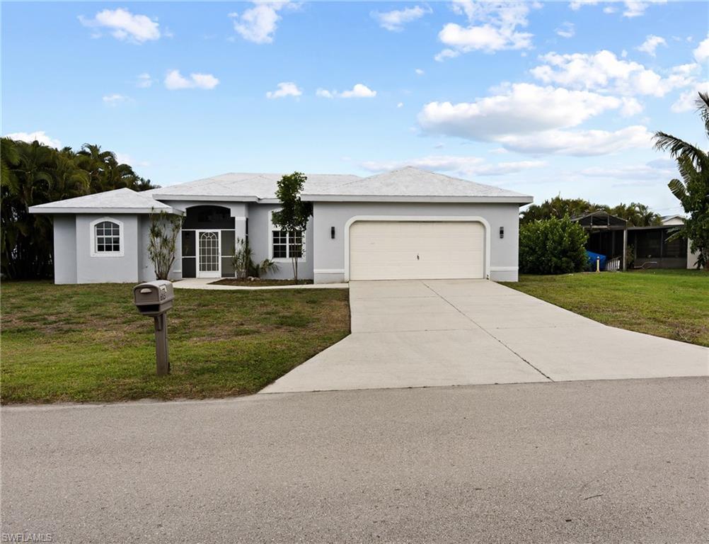Image 2: Single story home with a front yard, stucco siding, an attached garage, and concrete driveway