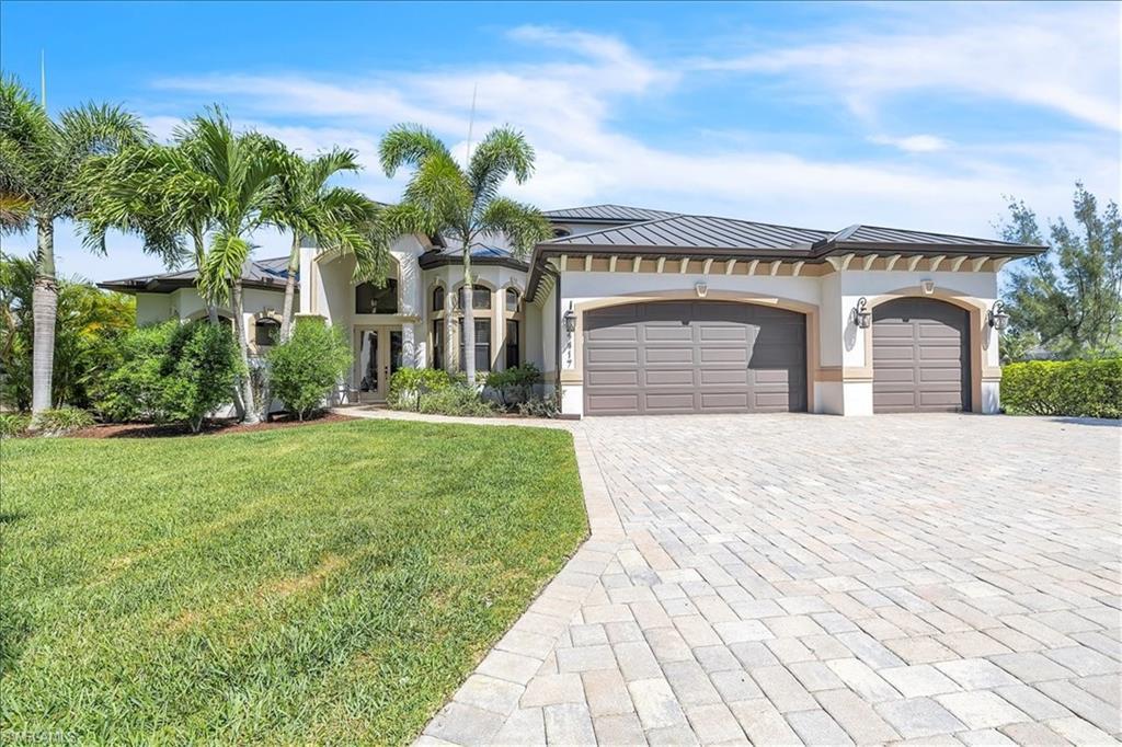 Image 4: Contemporary stucco exterior featuring a dark metal roof and two-car garage