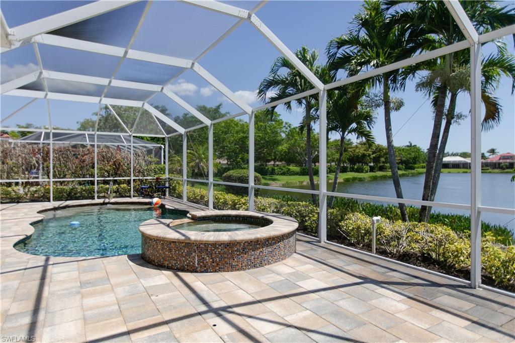 Image 3: View of pool with a water view, a patio area, a pool with connected hot tub.