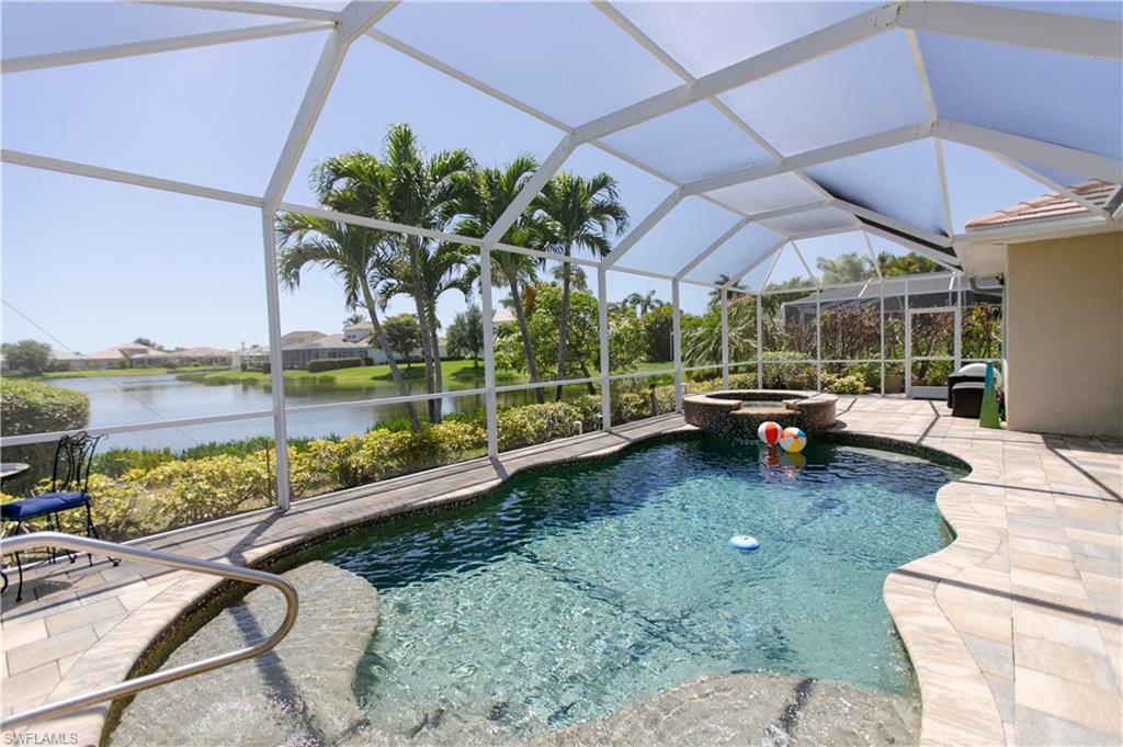 Image 4: View of pool featuring a water view, a patio area, a pool with connected hot tub.