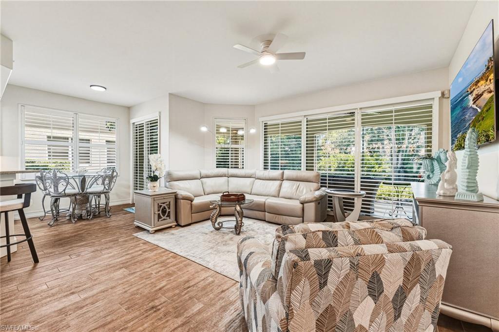Image 2: Stunning plantation shutters span the living room sliders and continue into the breakfast room, creating a cohesive and elegant look throughout.