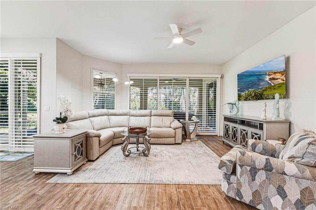 Image 3: Stunning plantation shutters span the living room sliders and continue into the breakfast room, creating a cohesive and elegant look throughout.