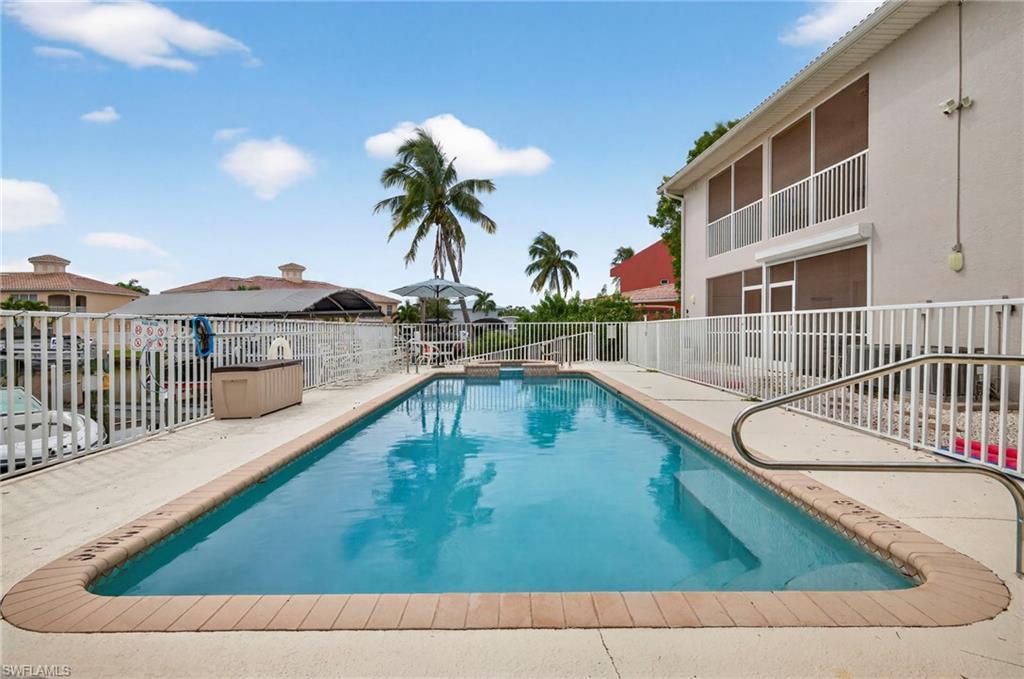 Image 3: View of pool featuring a patio area and a pool with connected hot tub