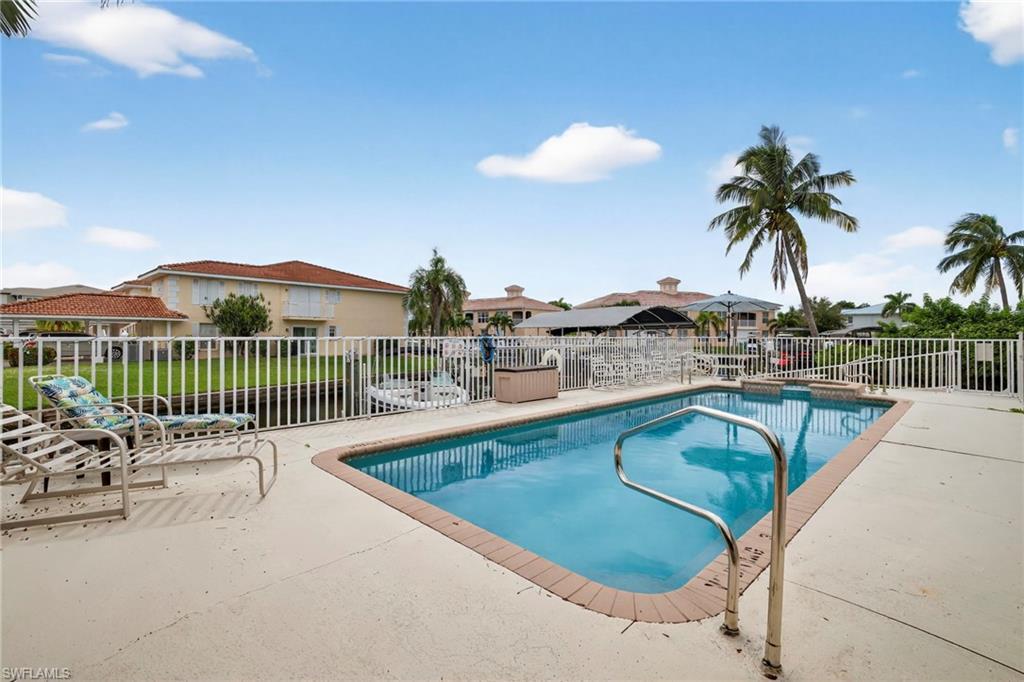 Image 4: View of pool featuring a patio area and a residential view