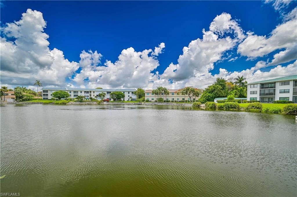 Image 4: Waterfront property featuring multi-story buildings with balconies, surrounded by lush green landscaping and mature palm trees