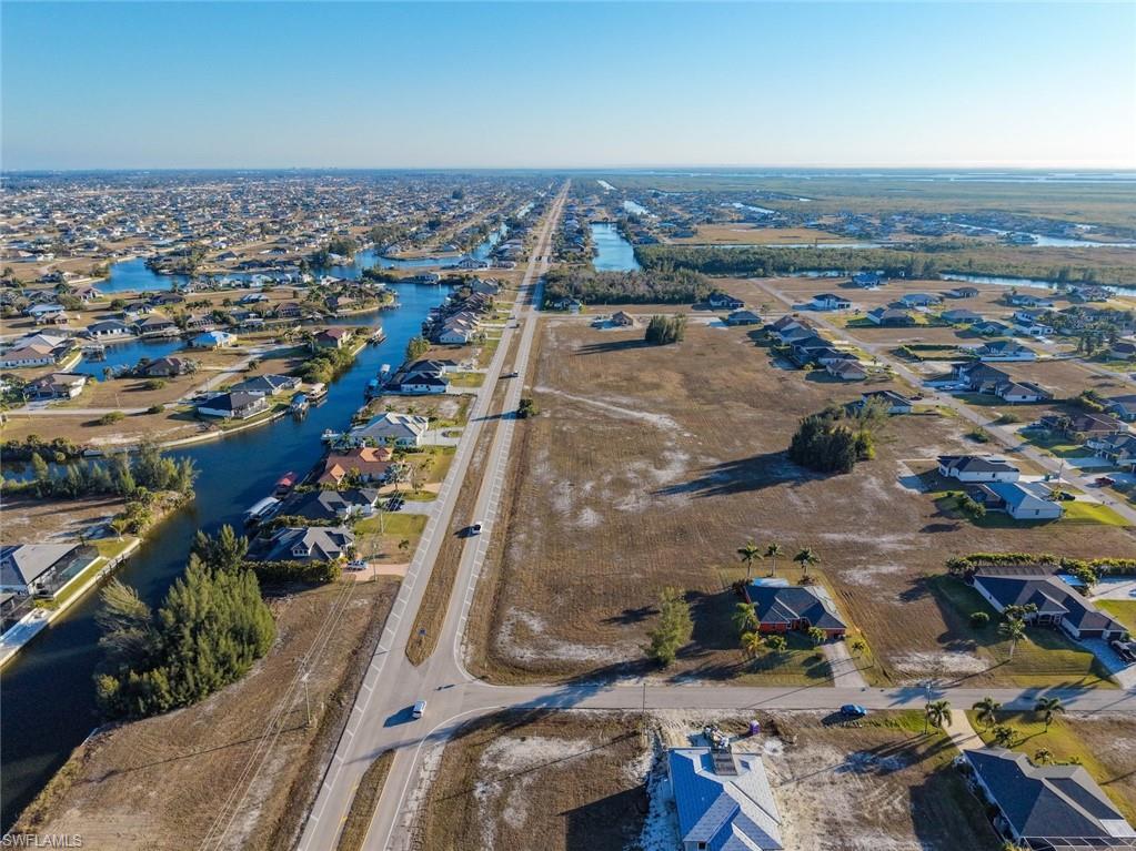 Image 4: View of property location featuring nearby suburban area and a large body of water
