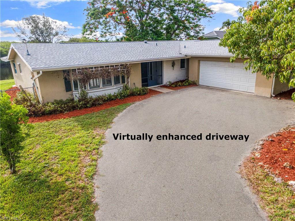 Image 2: Ranch-style residence featuring a gray shingle roof, a light-colored exterior, and an attached two-car garage