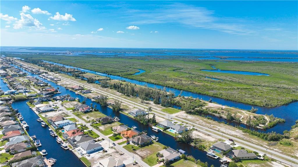 Image 2: Aerial perspective showcasing a residential area with extensive canal frontage, numerous properties featuring private boat docks, and direct access to waterways
