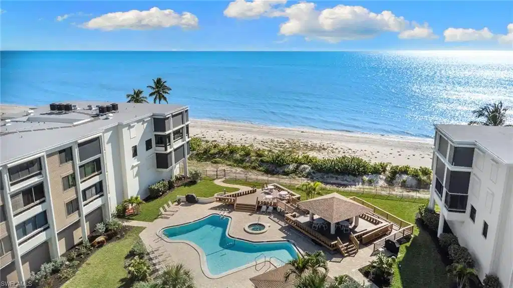 Image 1: Water view featuring local beach and a fenced backyard