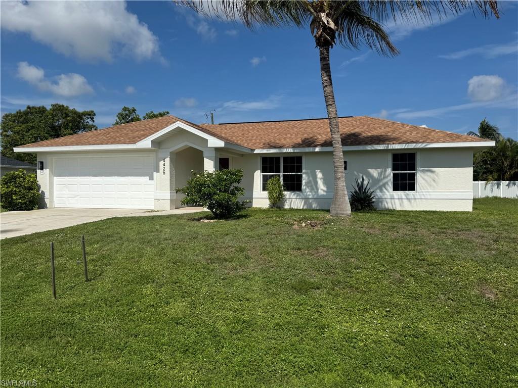 Image 1: White stucco exterior with a brown shingle roof