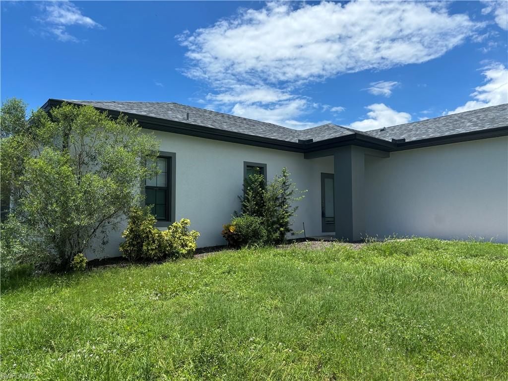Image 3: View of side of home featuring a lawn