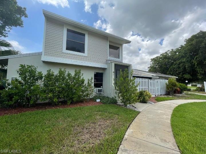 Image 3: Two-story residence featuring light-toned siding and stucco exterior finishes