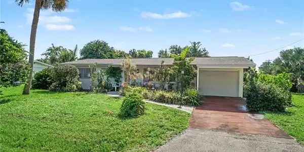 Image 2: Ranch-style exterior with an attached garage, featuring a paved driveway and a front walkway