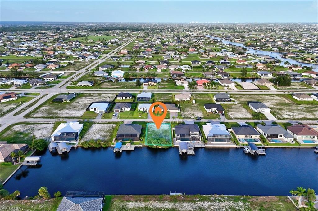 Image 3: Canal-front lot in a developed residential area with multiple adjacent homes featuring private boat docks