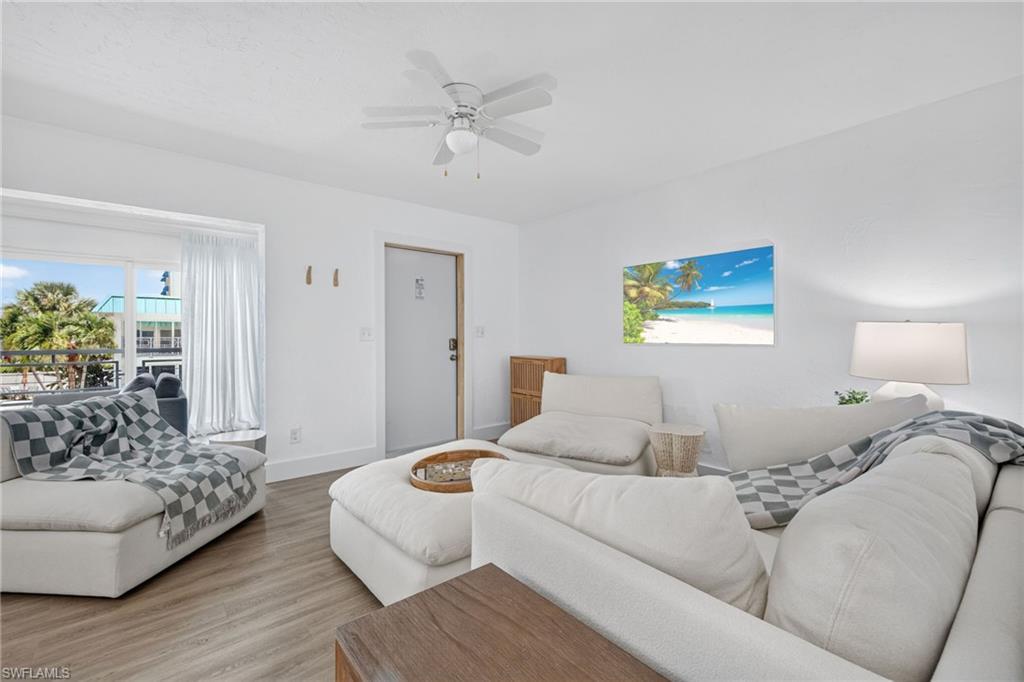 Image 2: Bright interior space featuring a ceiling fan, wood-finish flooring, and a window with exterior views
