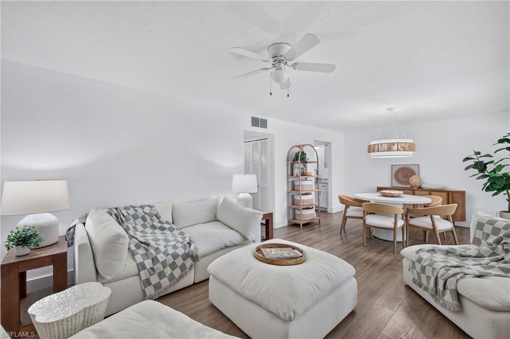 Image 4: Open-concept living and dining area featuring wood-finish flooring, recessed lighting, and a ceiling fan