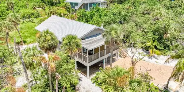 Image 3: Aerial view of property and surrounding area featuring a tree filled landscape