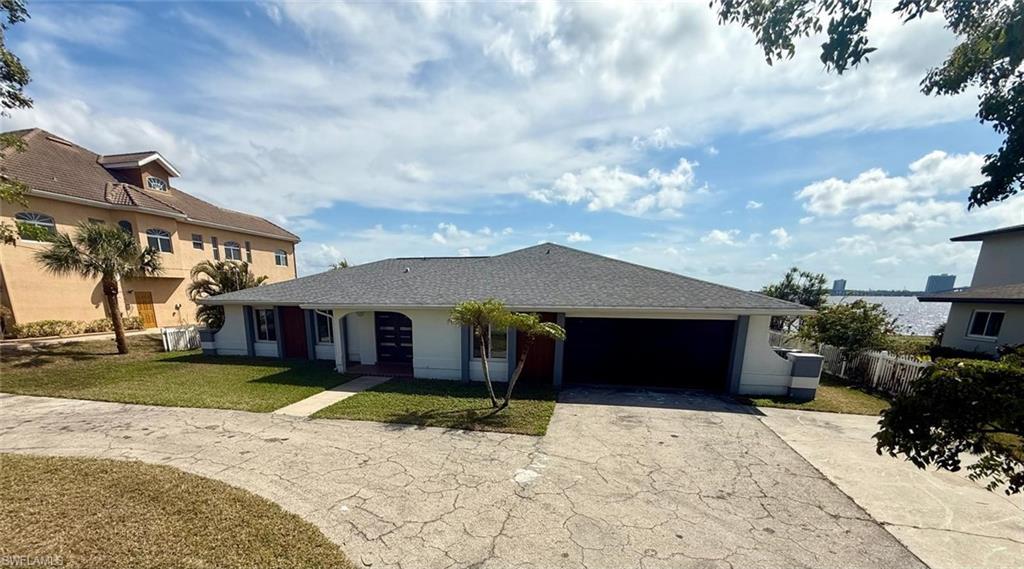 Image 1: Single story home with stucco siding, a front yard, fence, a garage, and driveway