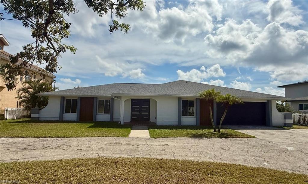Image 3: Single story home featuring a garage, fence, driveway, stucco siding, and a front yard
